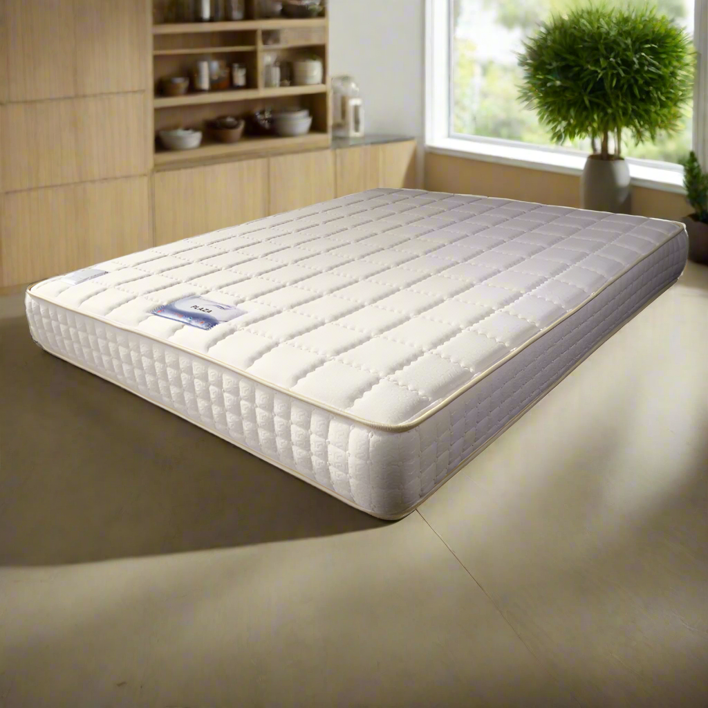 Quilted white mattress with gray sides, single corner view