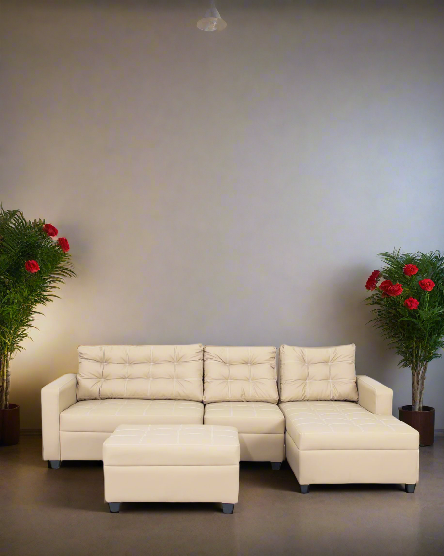 Beige L-shape sofa with tufted back cushions, chaise seat, and matching ottoman.