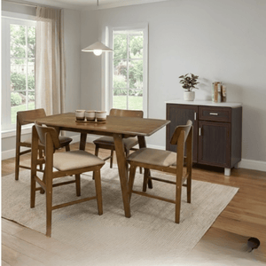 Dining room with wooden table and chairs on a light rug.