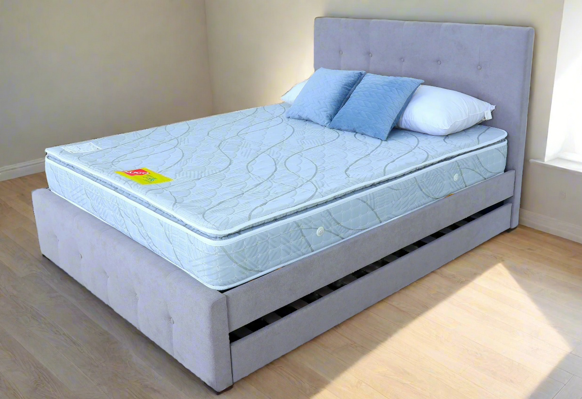 FORZA Mattress by Ambassador Bed on upholstered bed frame with light blue quilted top