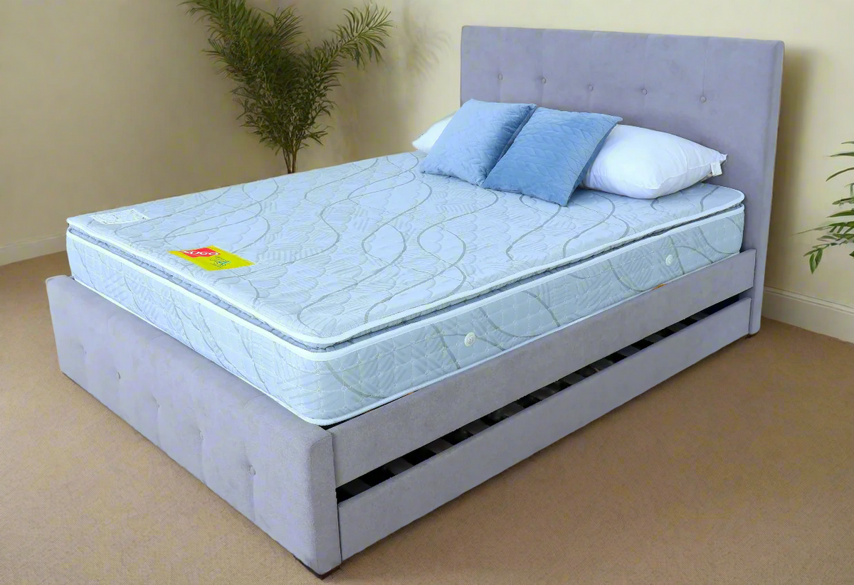 FORZA Mattress by Ambassador Bed on gray upholstered base with light blue quilted surface