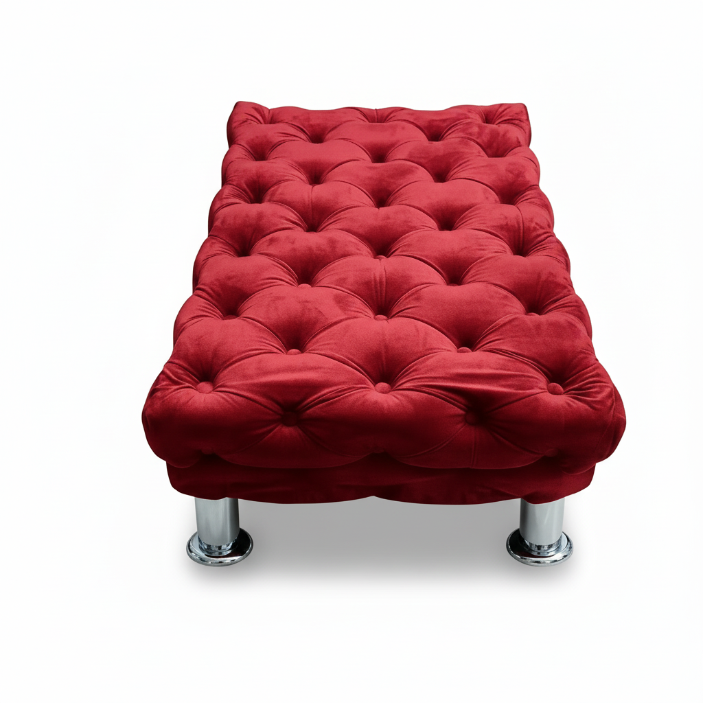Tufted velvet big ottoman, maroon/red fabric with rounded arms and chrome legs.