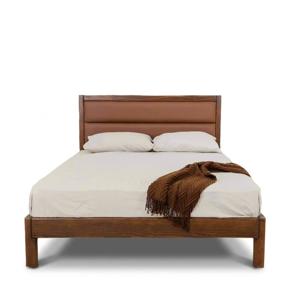 Queen bed frame with brown upholstered headboard and dark wood posts