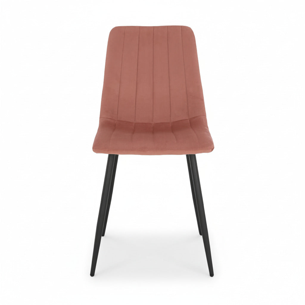 Pink upholstered dining chair with curved back and seat, channel seams, black metal legs