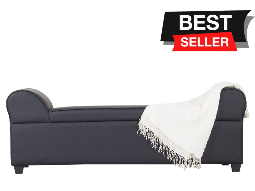 Lounge sofa with dark upholstery, rounded arms, and off-white blanket folded on right