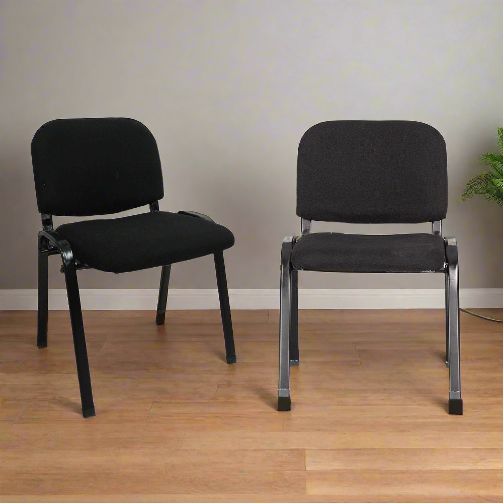 Set of 2 black visitors chairs with padded seats and backs on metal frames