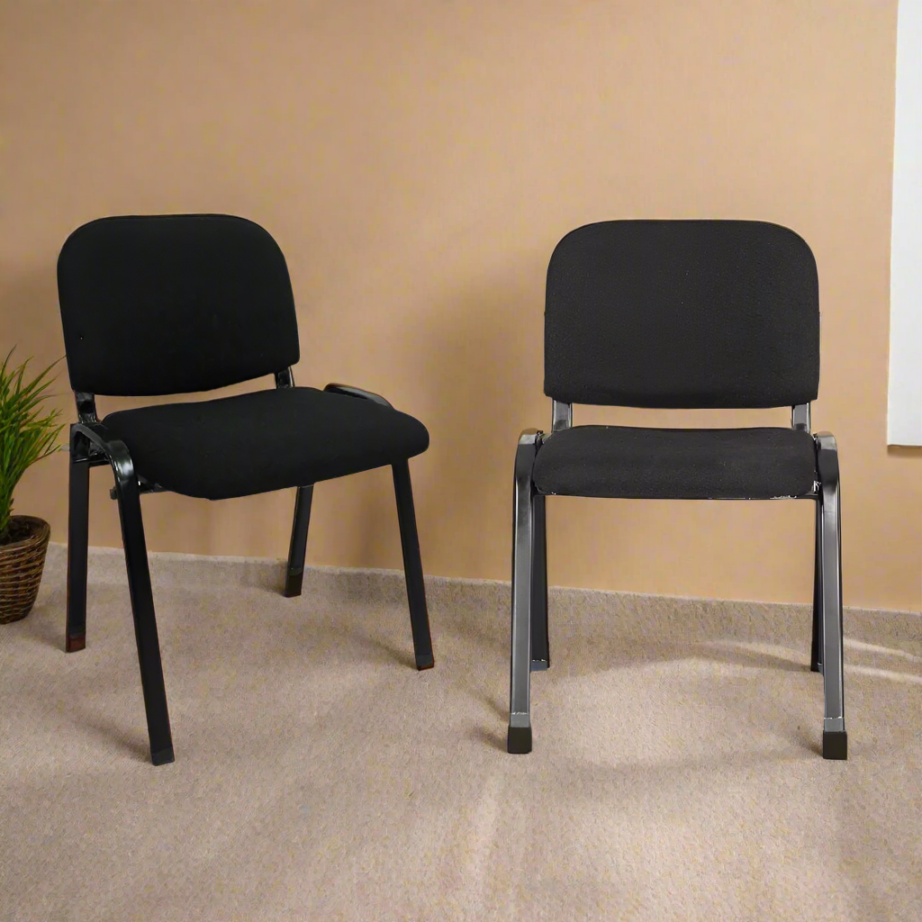 Set of 2 black visitors chairs with padded seats and backs on metal legs
