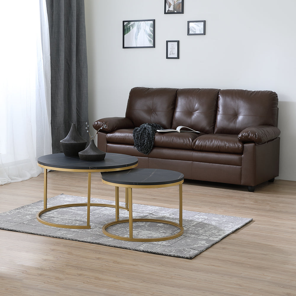 Nesting table set with two round dark gray tops and gold metal base frames