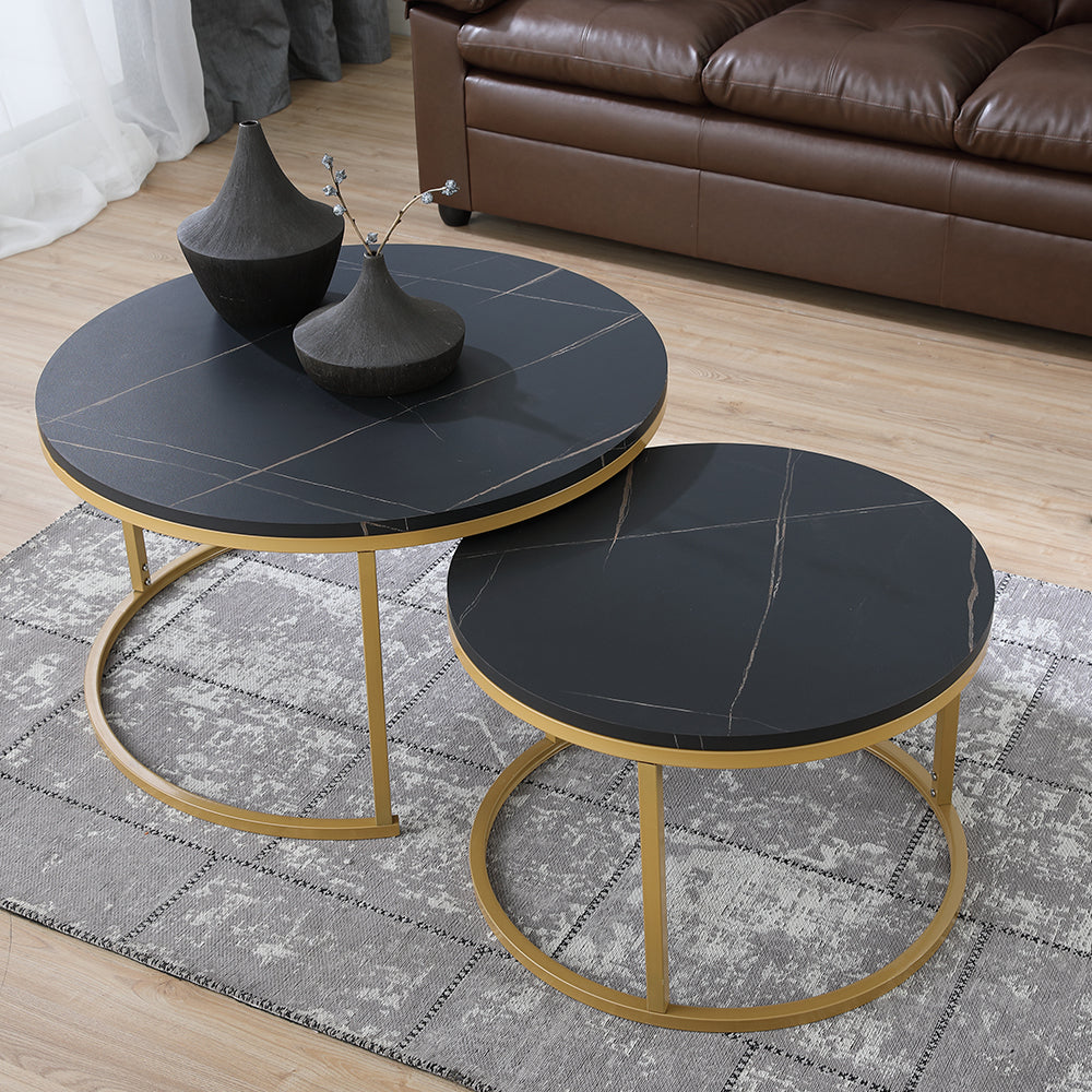 Two-piece nesting table set with dark gray marble-look tops and gold metal bases