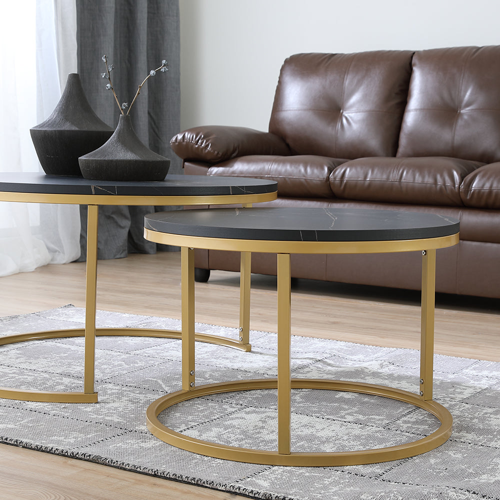 Round nesting table with dark gray marble-look top and gold curved base frame
