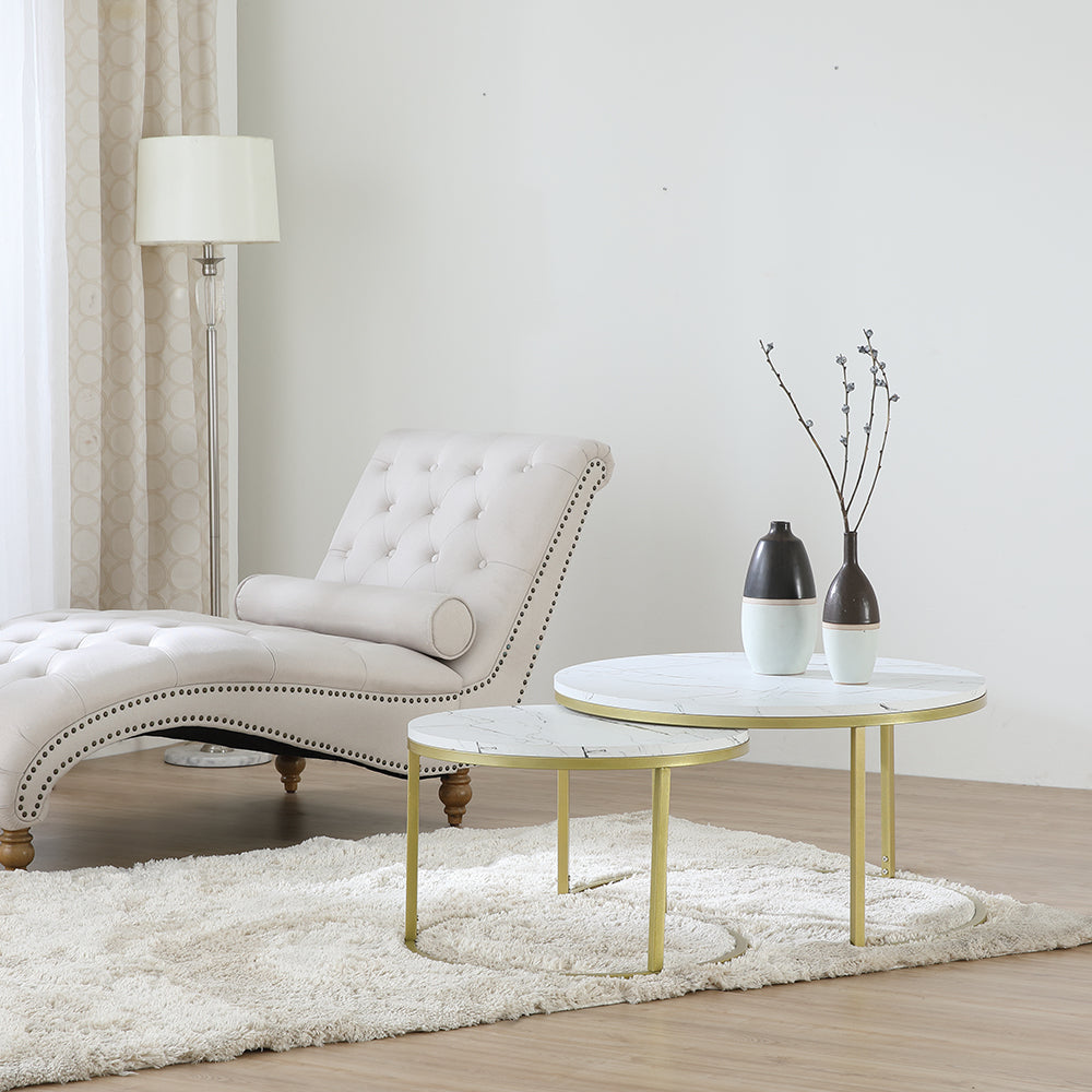 Nesting round coffee table set with white marble-look tops and gold legs in living room