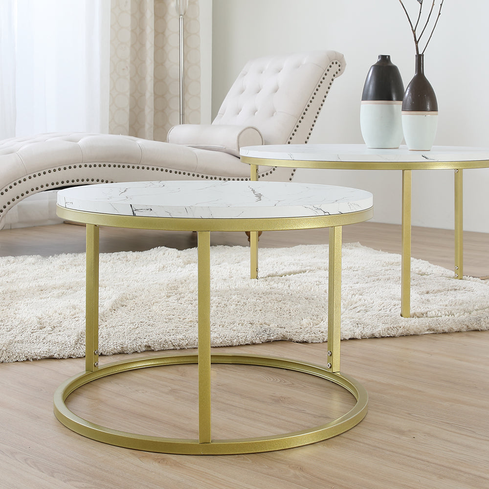Nesting round coffee table with white marble-look top and gold circular base in room