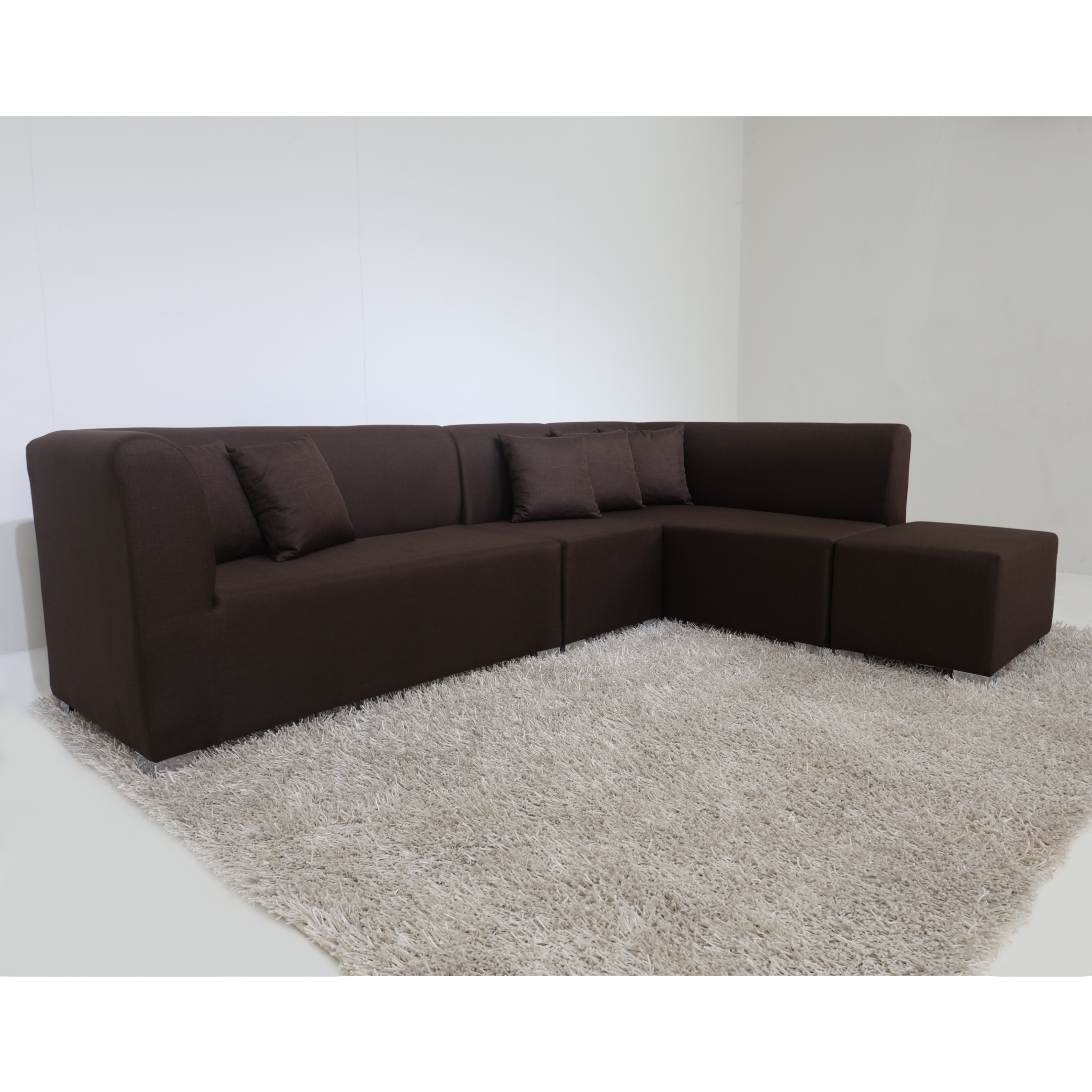 Dark brown L-shape sofa with tufted back cushions and chaise corner