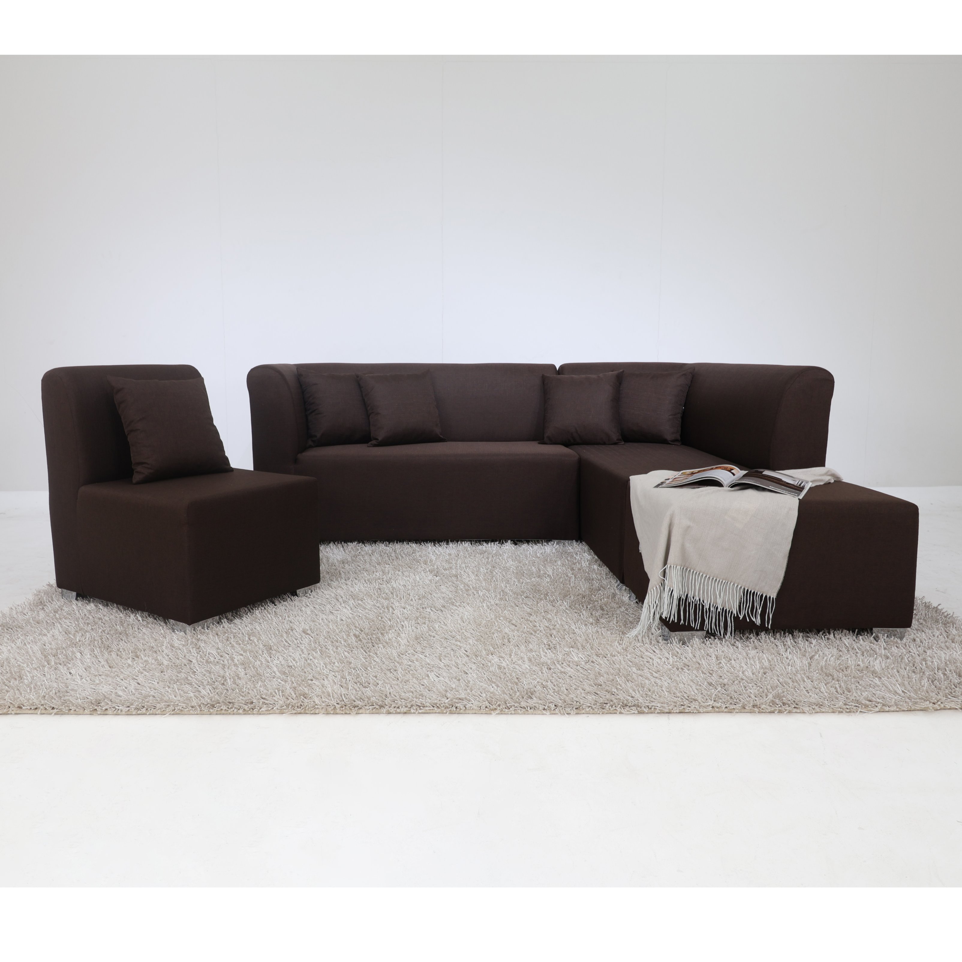 Dark brown L-shape sofa with chaise arm, throw blanket, and center ottoman stool