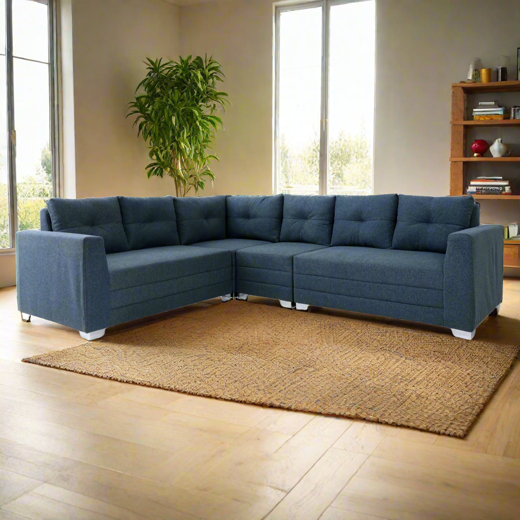 Blue corner sectional sofa with tufted seat backs and white block feet, chaise style