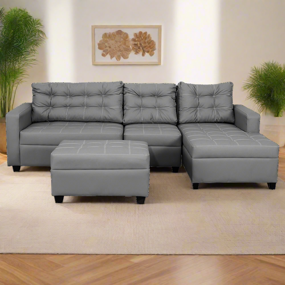 Gray L-shape sofa with tufted cushions, chaise seat, and matching ottoman.