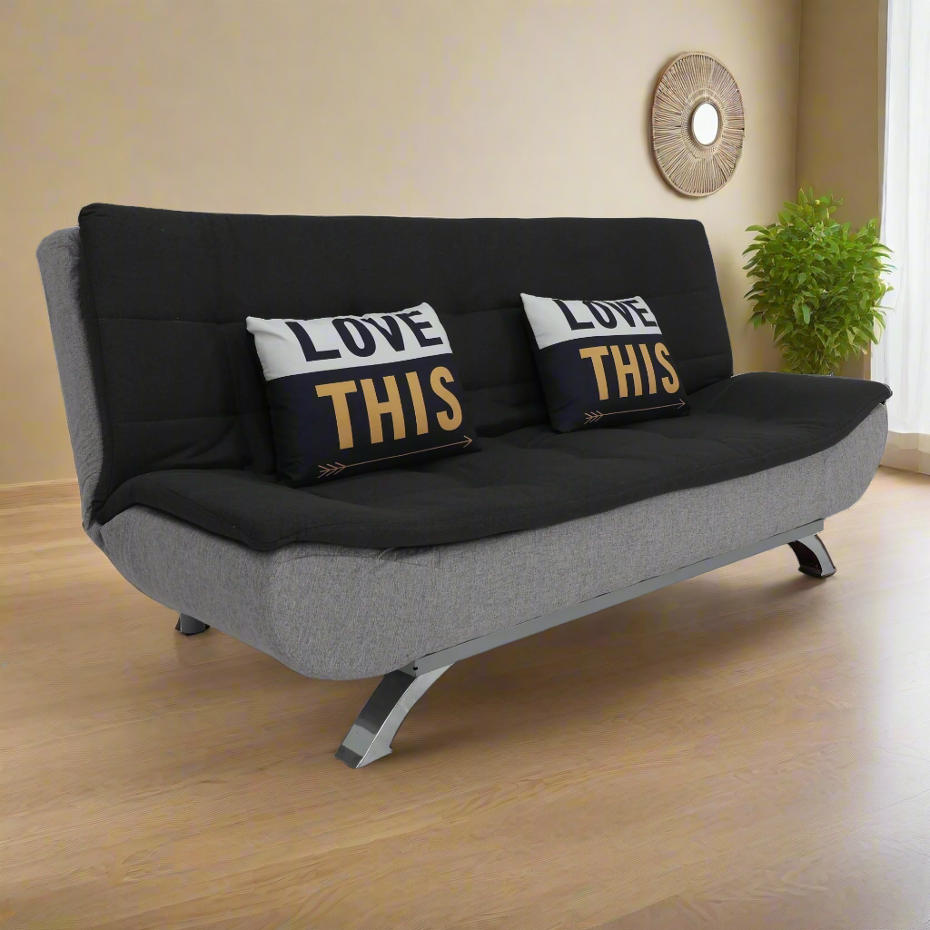 Black and gray sofabed with two “LOVE THIS” pillows and metal base