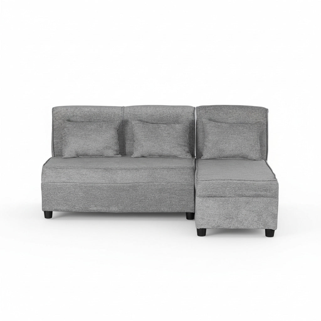 Grey L-shape sofa viewed from front, with three back pillows and chaise