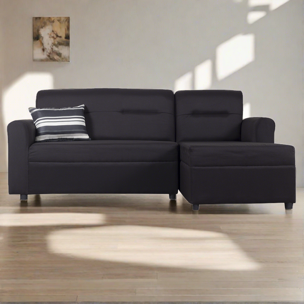 Dark L-shape sofa with seat cushions and black-and-white striped throw pillow