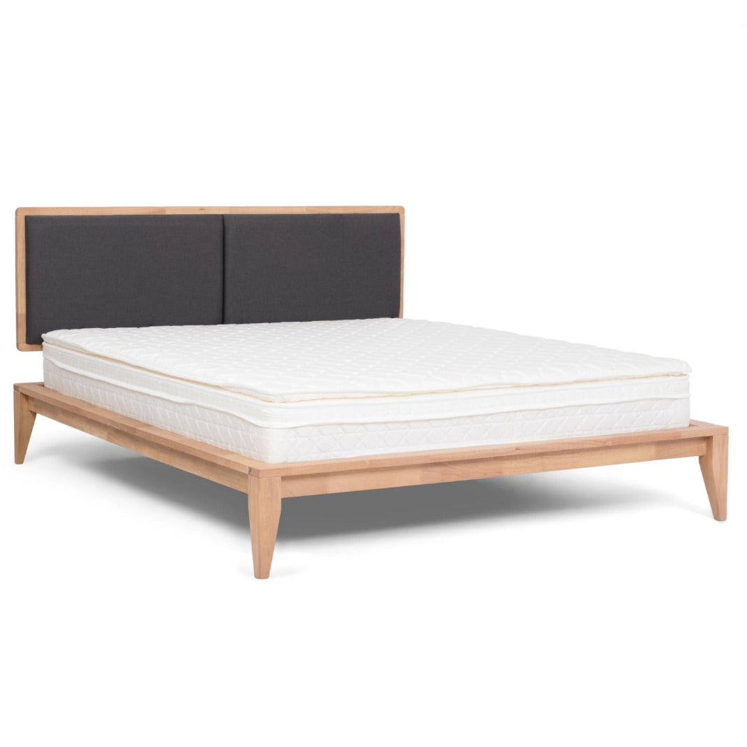 SINCLAIRE queen bed shown at an angle with light wood frame, charcoal headboard and white mattress
