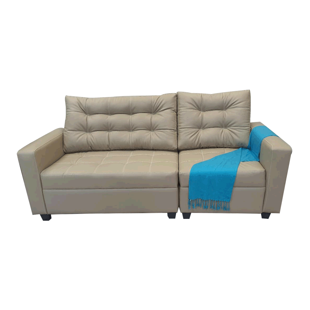 Gray modular sofa with tufted cushions, armrests, and blue throw blanket