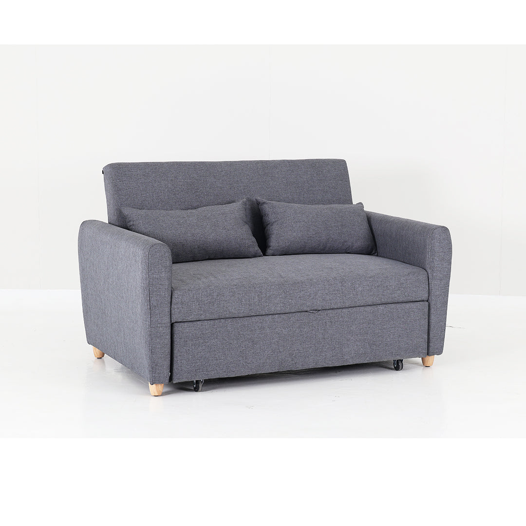 Grey upholstered sofa bed with stacked back cushions and visible hinge legs