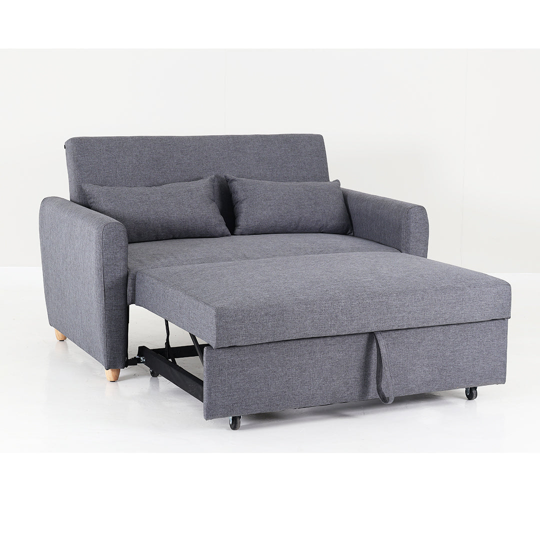 Grey fabric sofa bed with open pull-out mattress and padded armrests