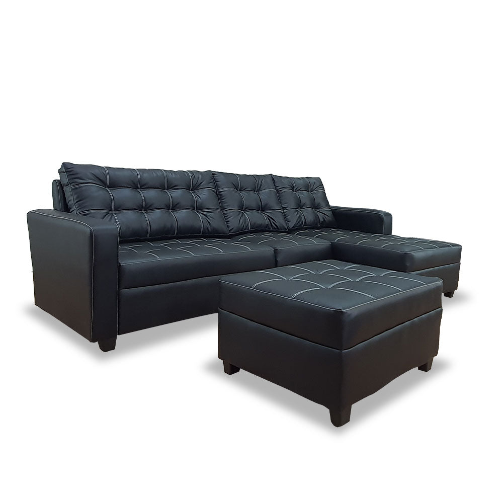 Dark gray L-shape sofa with tufted back cushions and chaise ottoman seat
