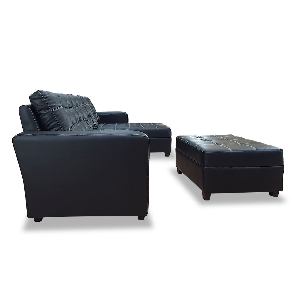 Black L-shape sofa with tufted seat and back, paired with a square ottoman