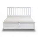 White bed frame with storage drawers on a white background