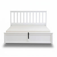 White bed frame with storage drawers on a white background