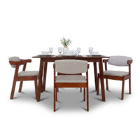 Dining table set with four chairs on a white background