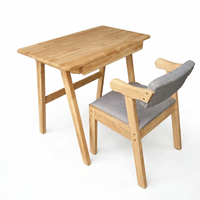 Natural wood study desk with side chair; gray cushion and light wood armrests