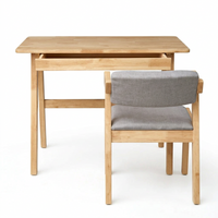 Natural wood study desk with open shelf and side chair; gray upholstered backrest