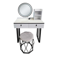 White vanity dresser with round mirror, two drawers, and hex stool with padded seat
