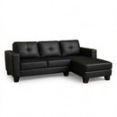 Black L-shape sectional sofa with padded armrests, tufted back cushions, chaise seat