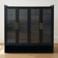 Black four-door shoe cabinet with ribbed glass panels and gold-tone handles