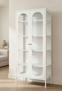 JIRAH white display cabinet with arched glass doors, adjustable shelves, and slim legs