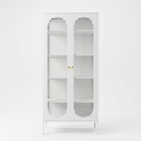 Front view of the white JIRAH display cabinet with arched glass doors and gold knobs