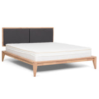 SINCLAIRE queen bed shown at an angle with light wood frame, charcoal headboard and white mattress